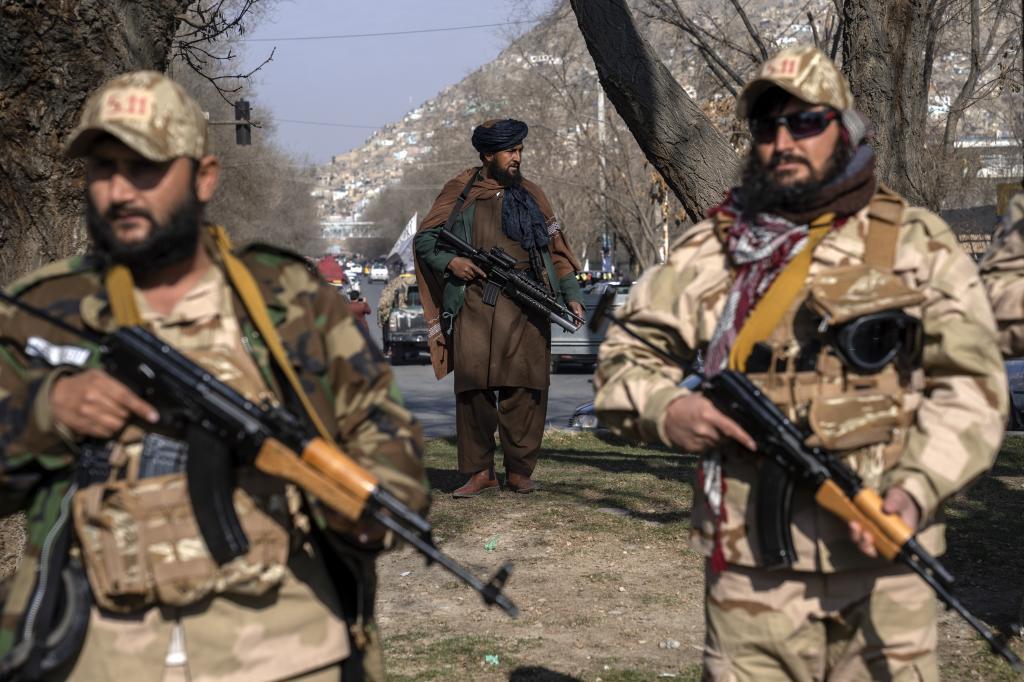 Taliban fighters stand guard in Kabul