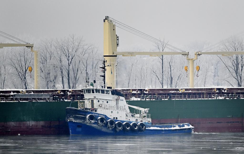 A tugboat tries to release the MV Maccoa after it ran aground in the St. Lawrence River in Vercheres