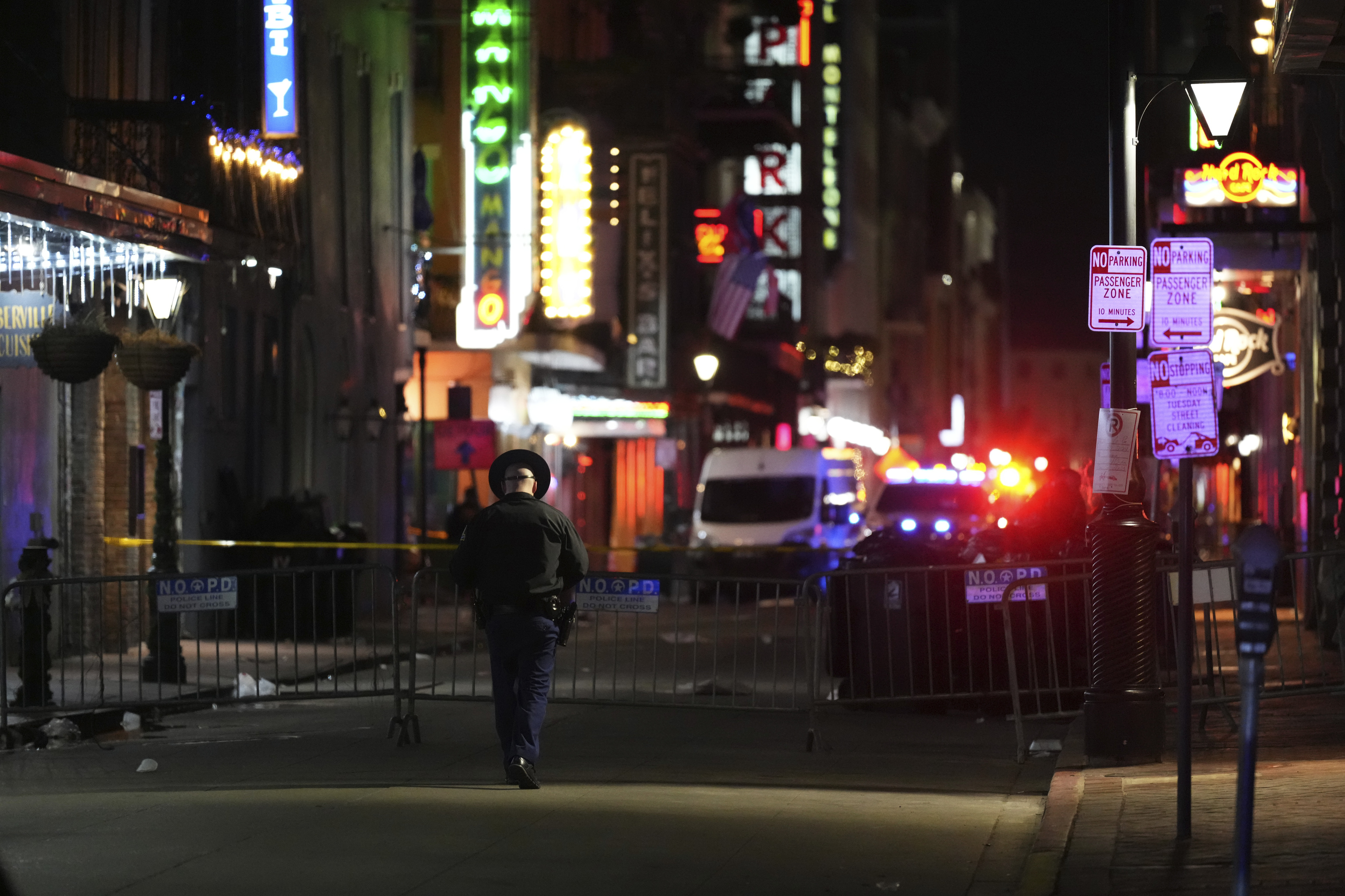 An officer walks along Conti Street after a vehicle drove into a crowd on New Orleans' Canal and Bourbon streets.