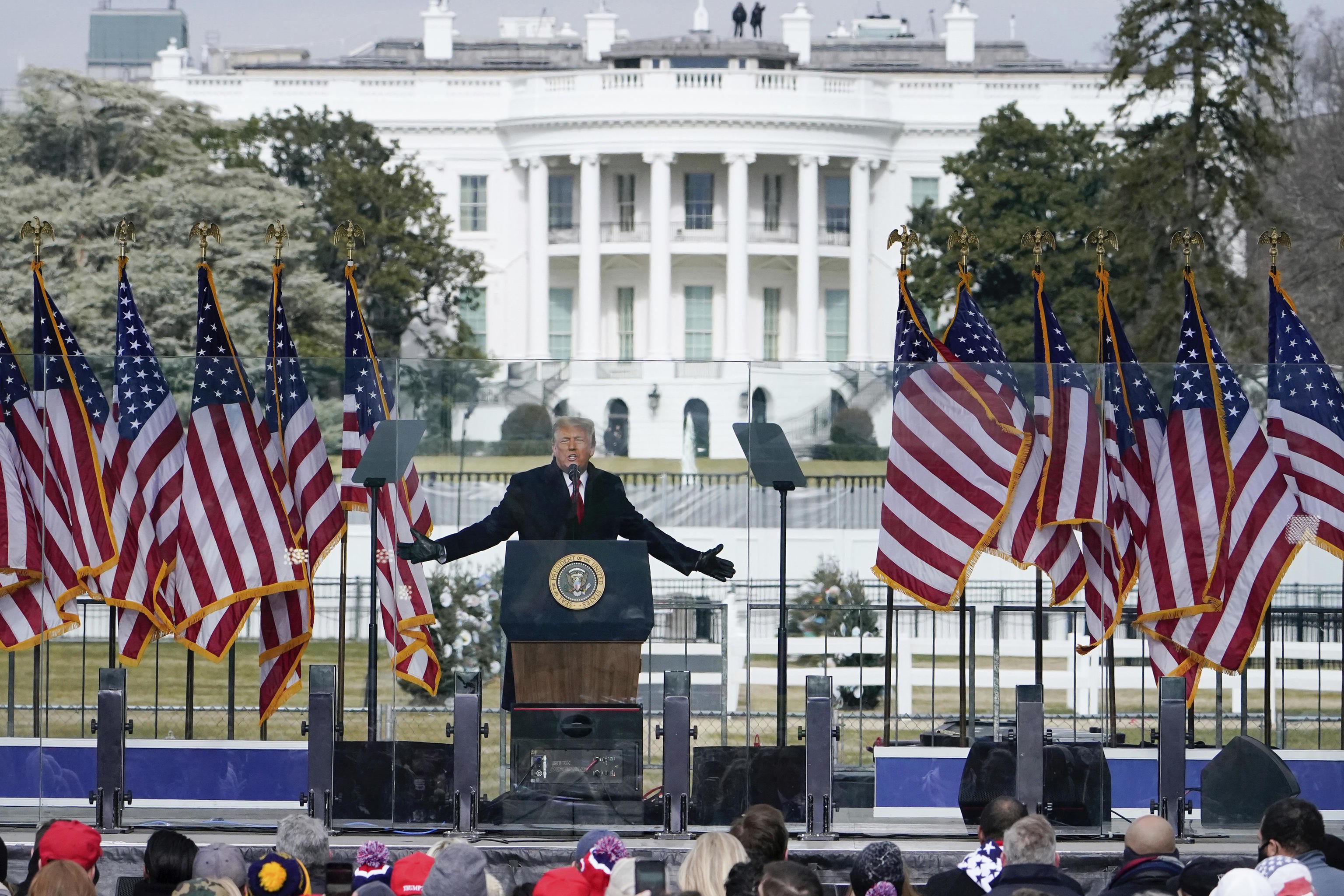 With the White House in the background, Trump speaks at a rally in 2021.