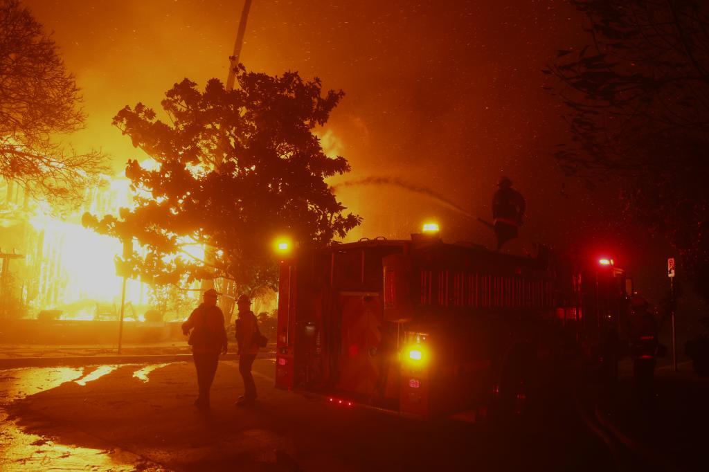 Firefighters battle the Palisades Fire in the Pacific Palisades neighborhood