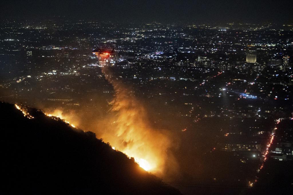 Water is dropped by helicopter on the burning Sunset Fire in the Hollywood Hills.