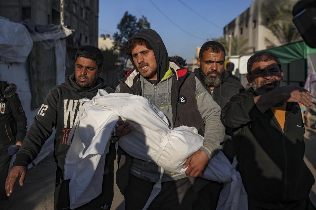 Palestinians carry the body of a relative killed in the Israeli bombardment of the Gaza Strip