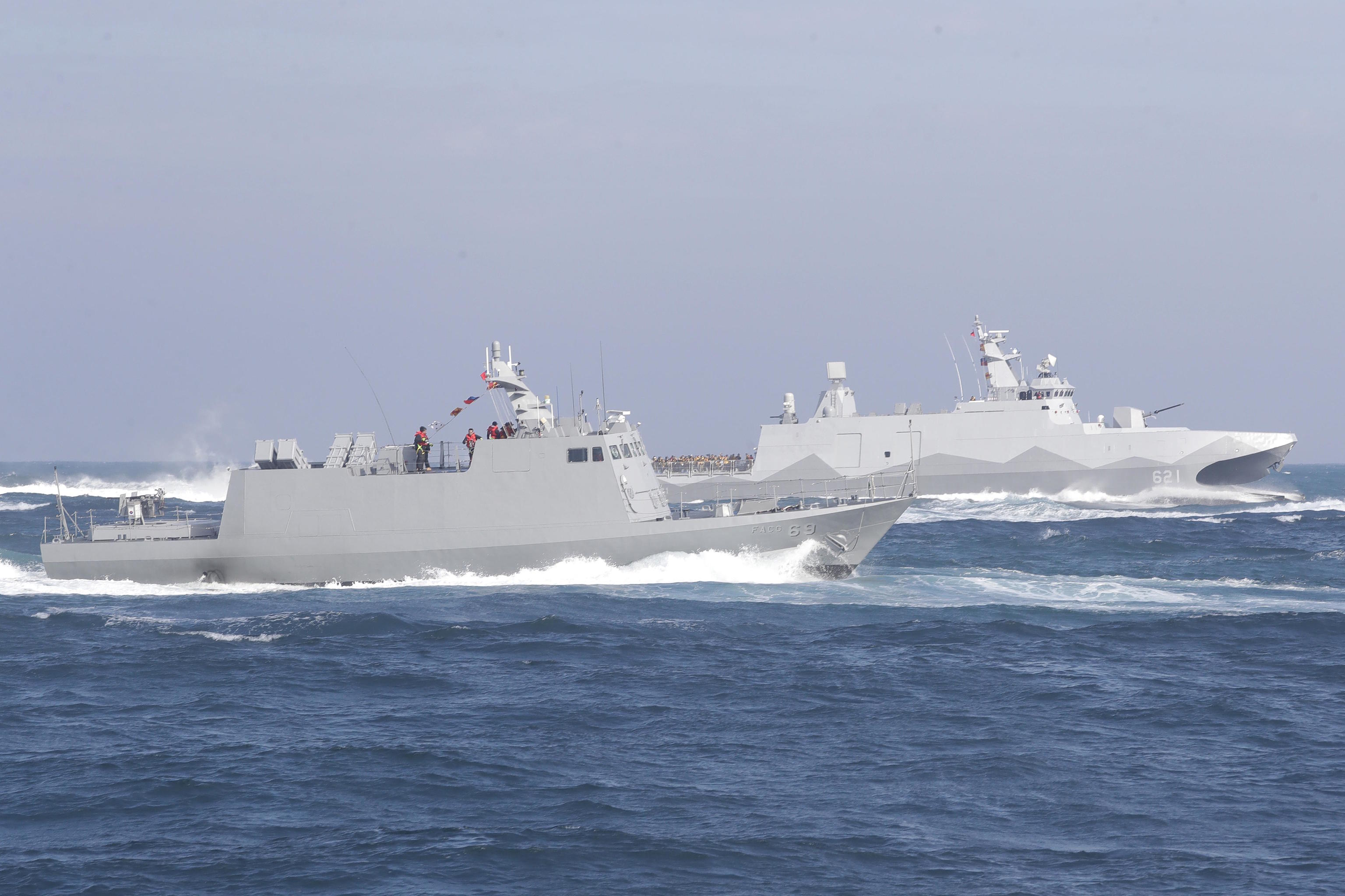 A Tuo Chiang patrol ship, right, and a Kuang Hua VI-class missile boat.