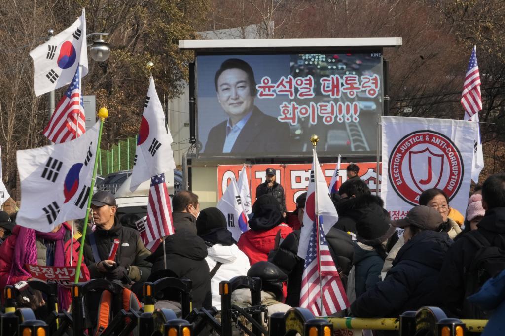 A TV screen shows a file image of South Korean President Yoon Suk Yeol