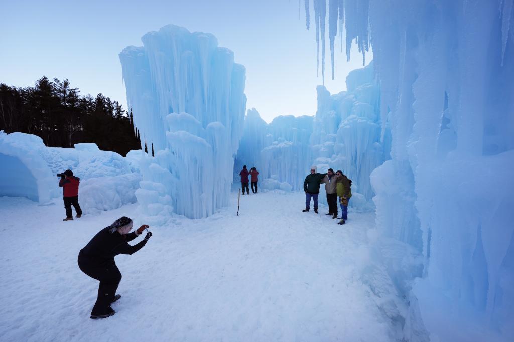 Nearly-made ice formations appear a glacial blue during daylight hours at the Ice Castles,