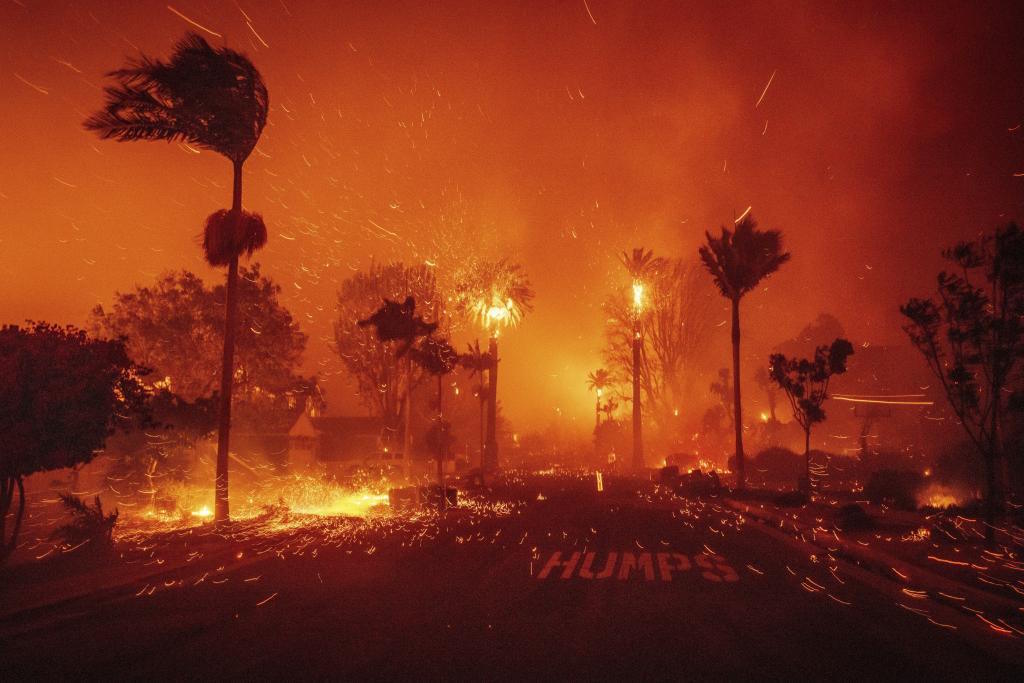 The Palisades Fire ravages a neighborhood amid high winds.