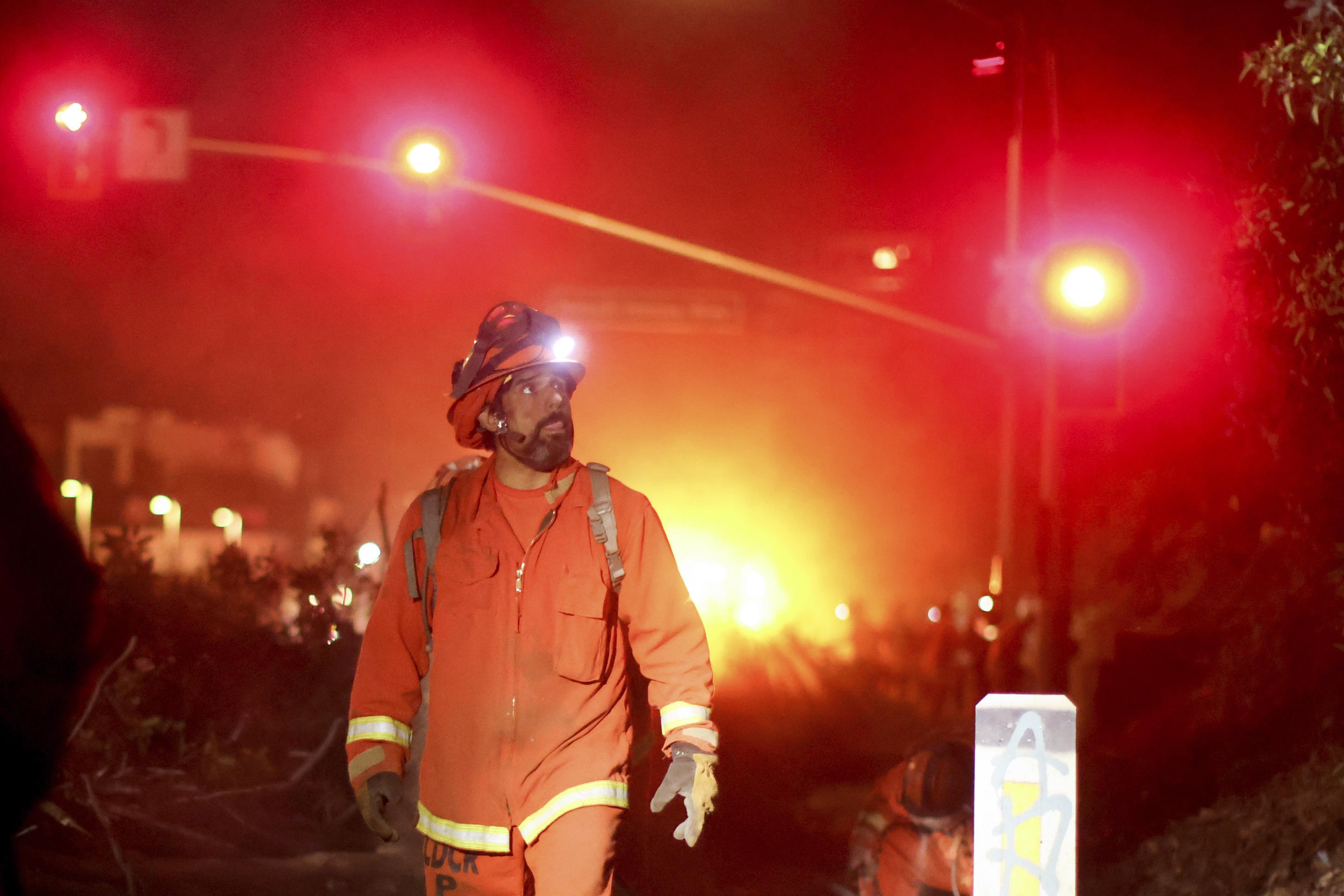 A California Department of Corrections hand crew works containment lines ahead of the Palisades Fire.