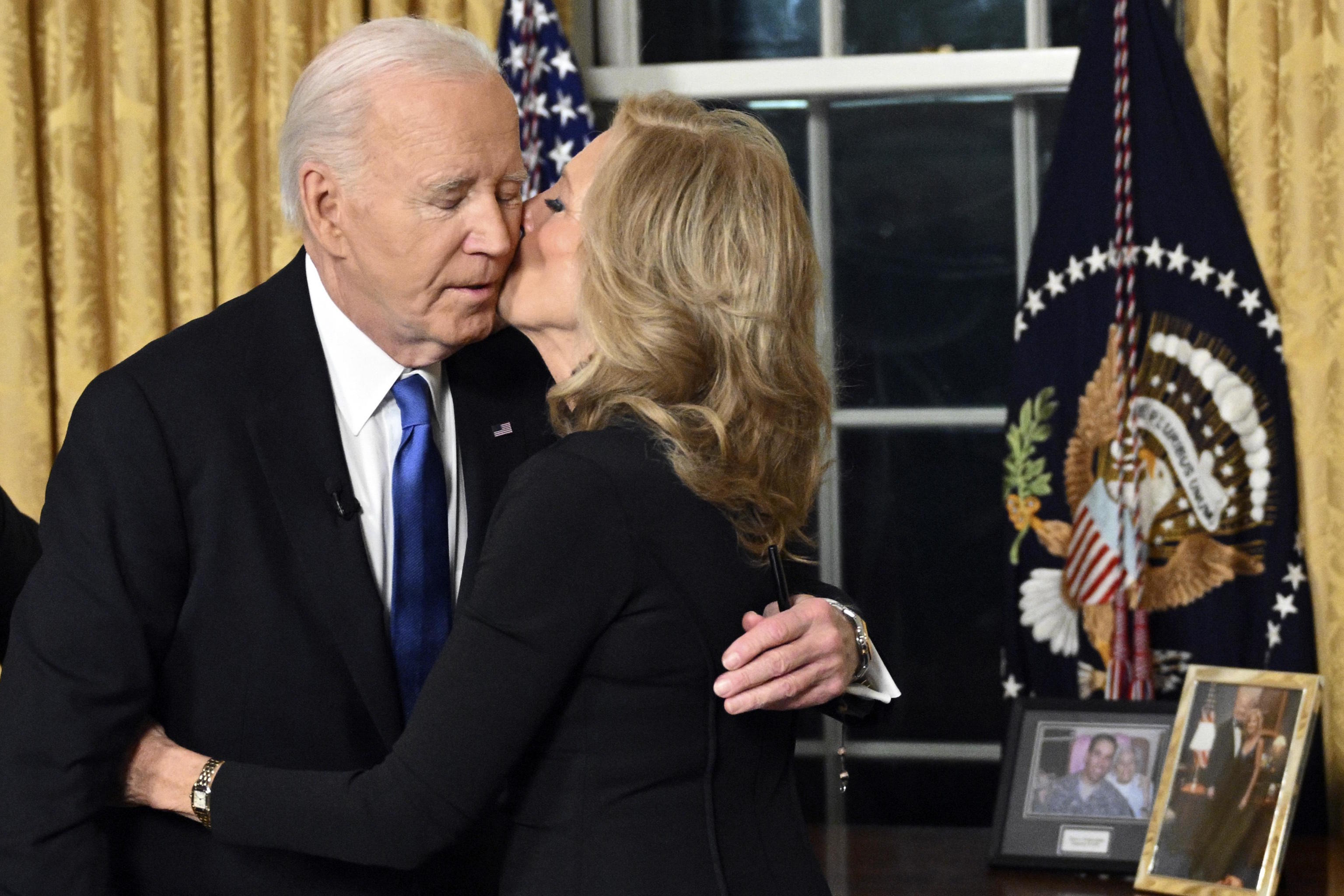 Biden hugs first lady Jill Biden after giving his farewell.