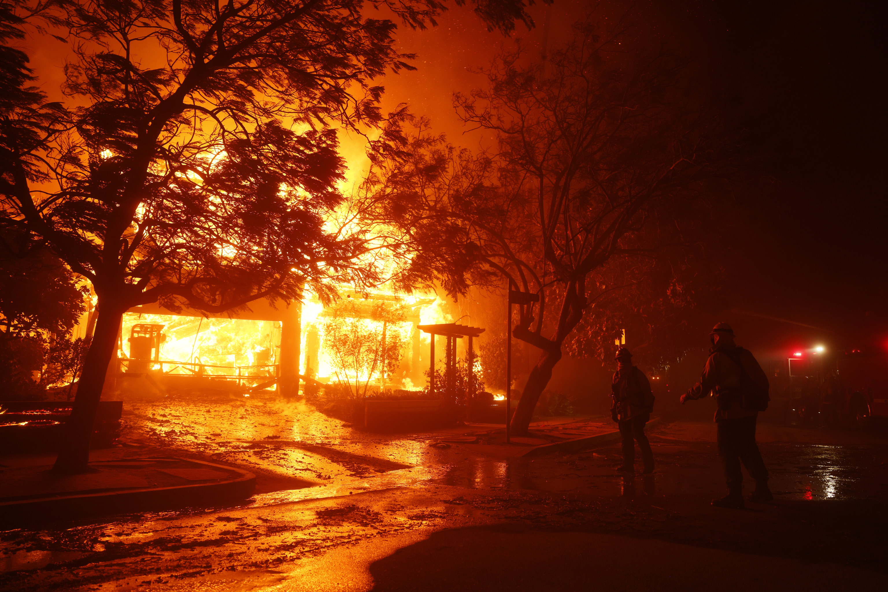 Firefighters battle the Palisades Fire in the Pacific Palisades neighborhood of Los Angeles.