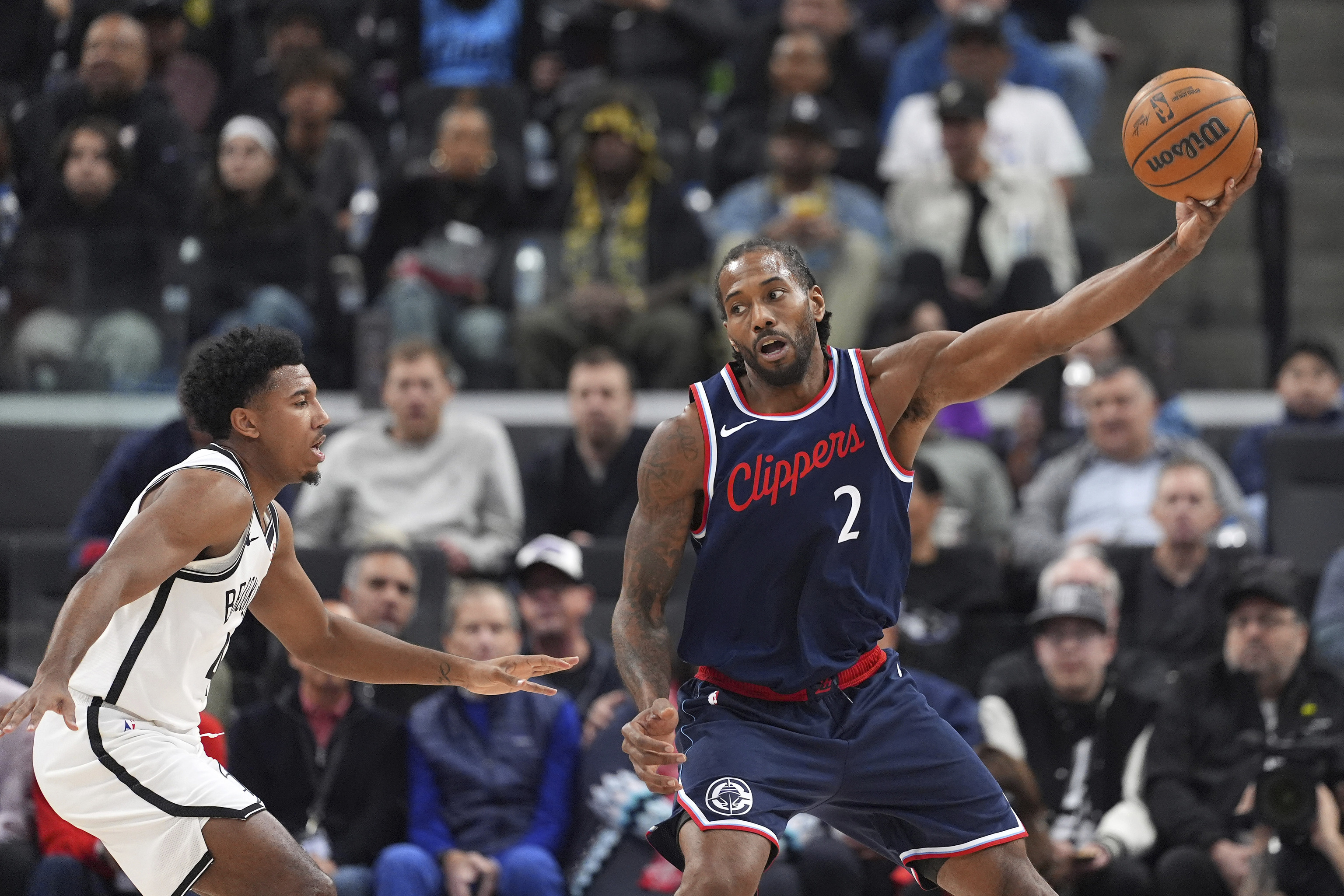 Los Angeles Clippers forward Kawhi Leonard, right, takes a pass as Brooklyn Nets guard Reece Beekman defends.