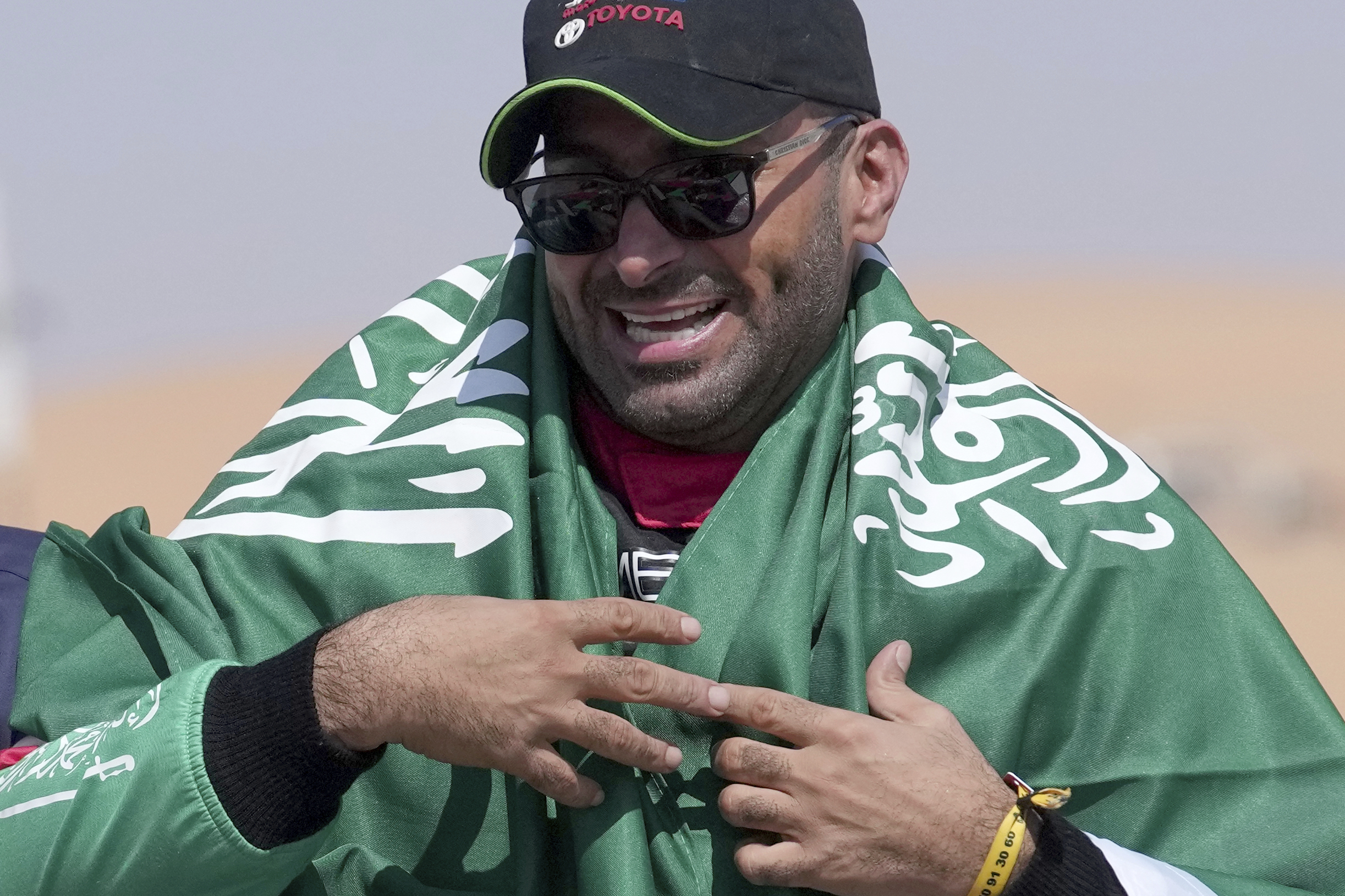 Driver Yazeed Al Rajhi, of Saudi Arabia, celebrates winning the Dakar Rally.