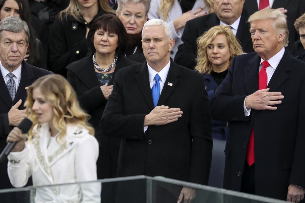 Vice President Mike Pence, center, and President Donald Trump, right, listen to the singing of the national anthem by Jackie Evancho