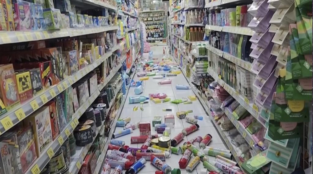 In this image from a video, bottles and cans are scattered on the floor at a convenience store in Tainan, Taiwan