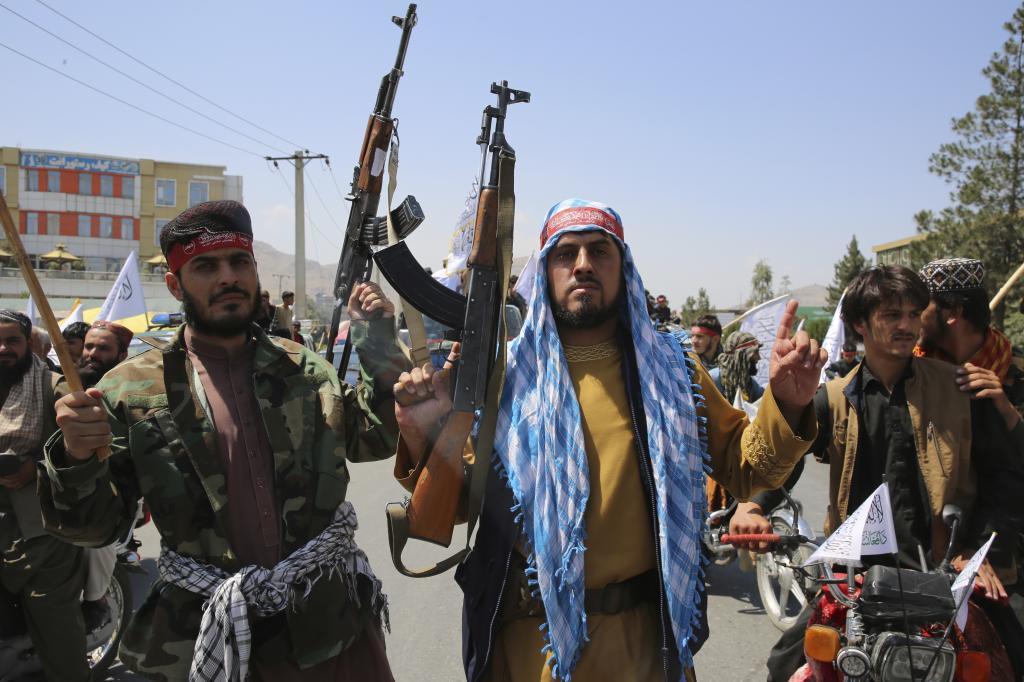 Taliban fighters celebrate the third anniversary of the withdrawal of US-led troops from Afghanistan