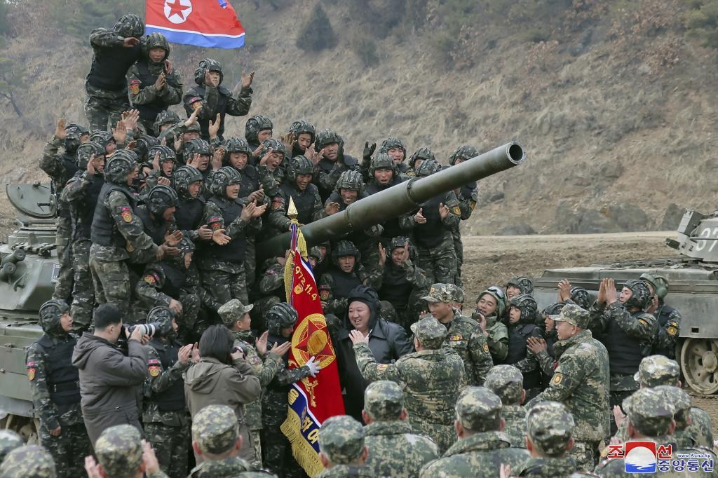 North Korean leader Kim Jong Un, center, meets soldiers who took part in a training in North Korea