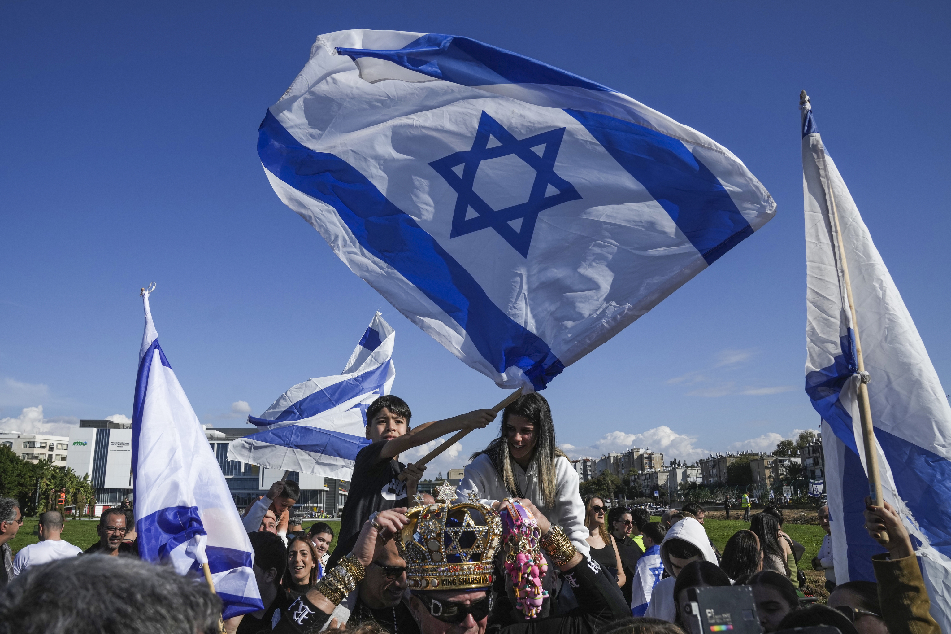 Hamas militants handed over four captive female Israeli soldiers to the Red Cross in Gaza City on Saturday after parading them in front of a crowd. Israel followed with the release of the first 70 of 200 Palestinian prisoners or detainees due to be set free as part of the fragile ceasefire in the Gaza Strip.