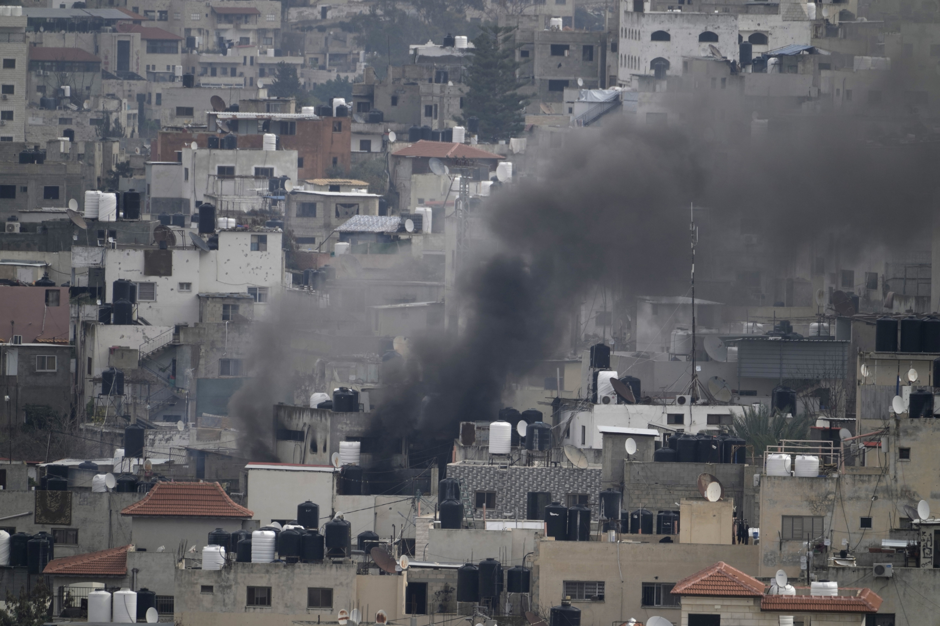 Smoke billows as homes are demolished in Jenin refugee camp.