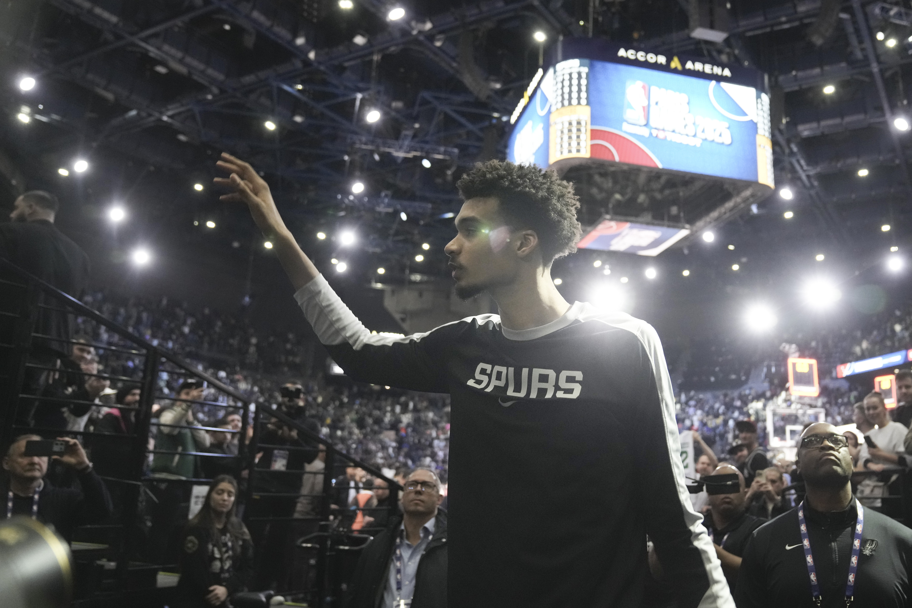 San Antonio Spurs center Victor Wembanyama (1) waves to fans as he leaves the court.