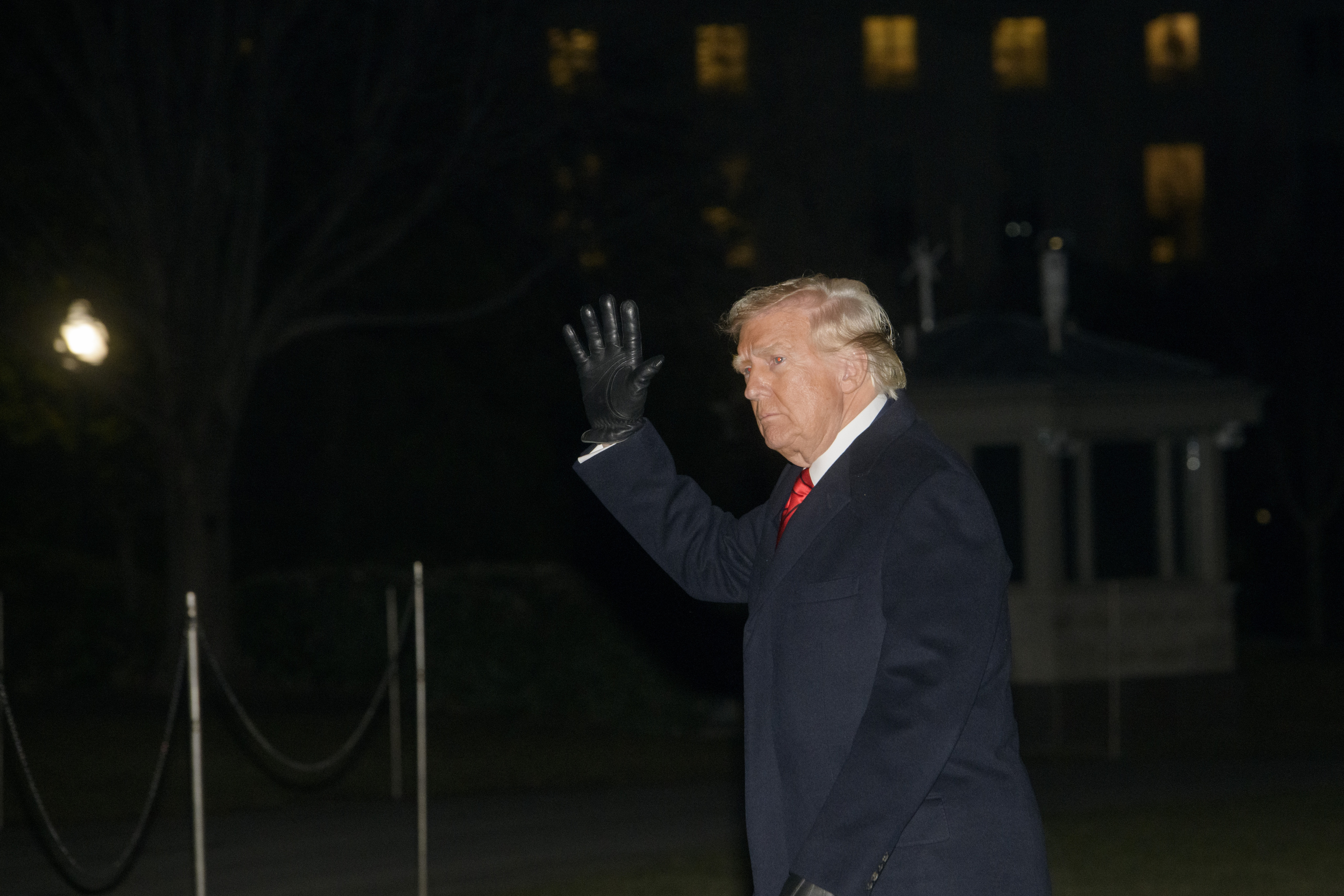 President Donald Trump waves as he walks from Marine One.