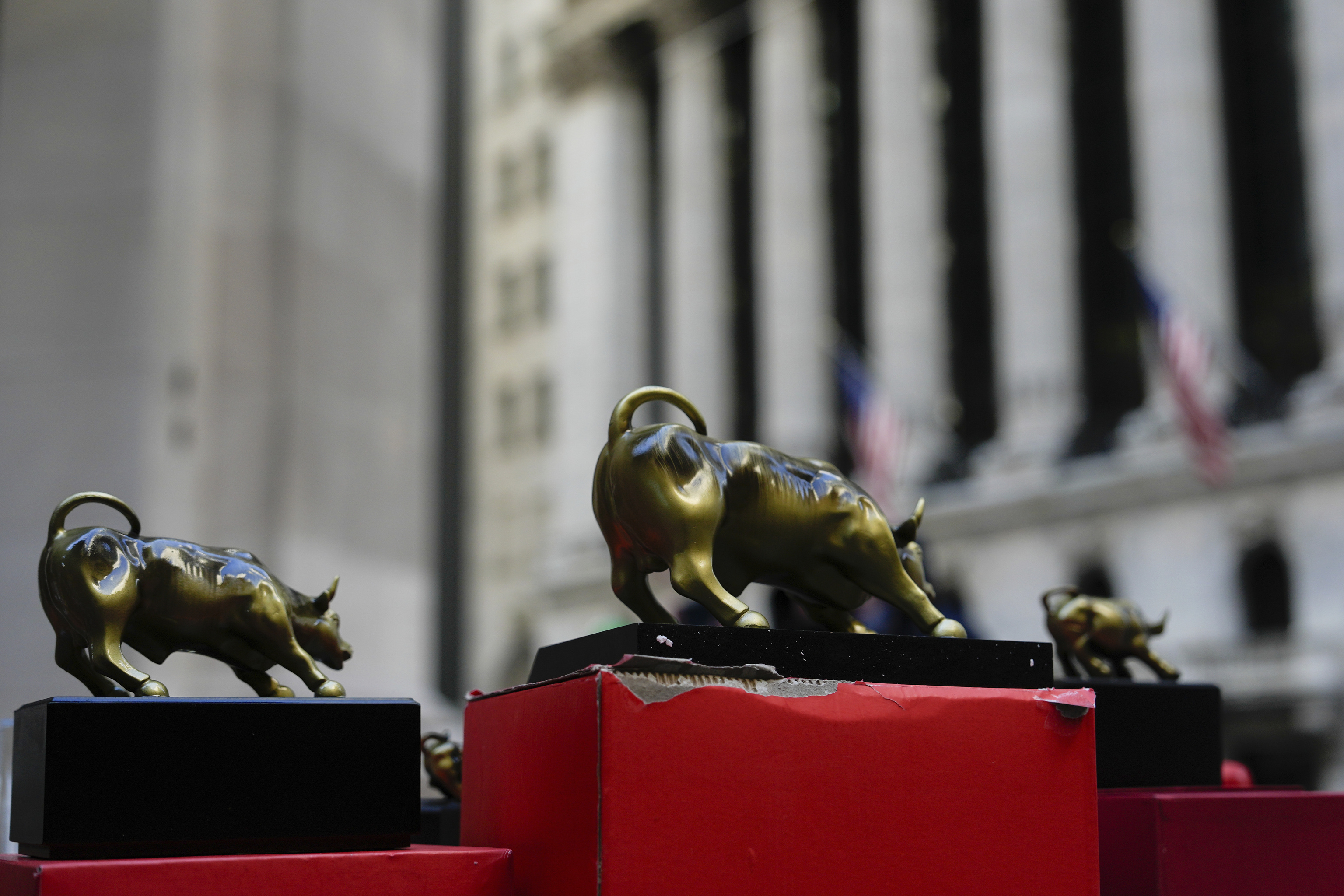 Wall Street bull figurines are sold outside the New York Stock Exchange.