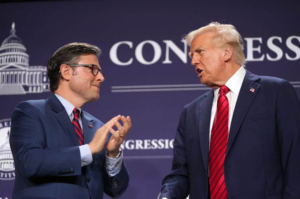 President Donald Trump talks with House Speaker Mike Johnson.