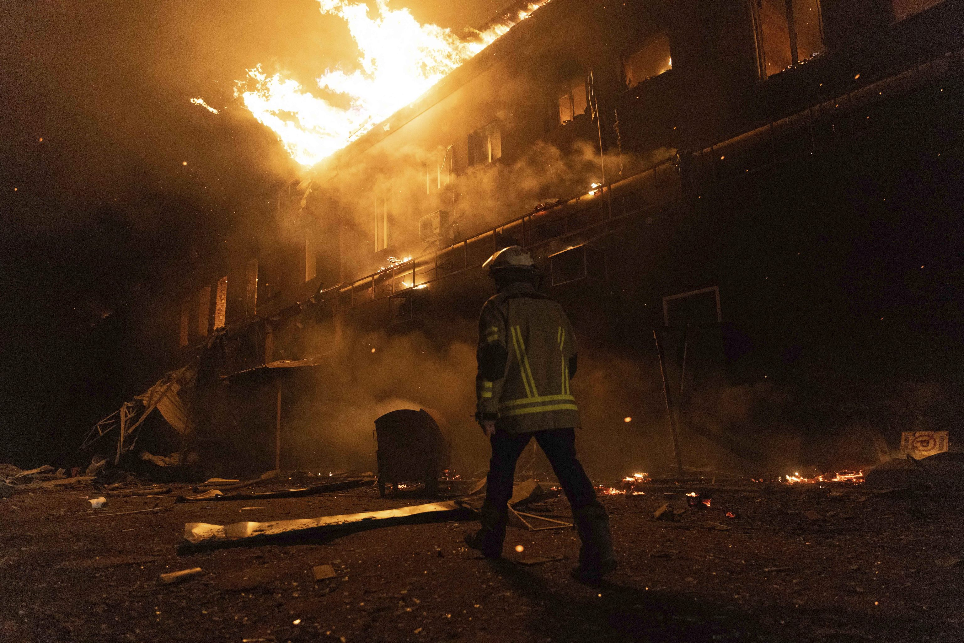 Firefighters extinguish a fire after a Russian attack on a civil factory in Kharkiv.