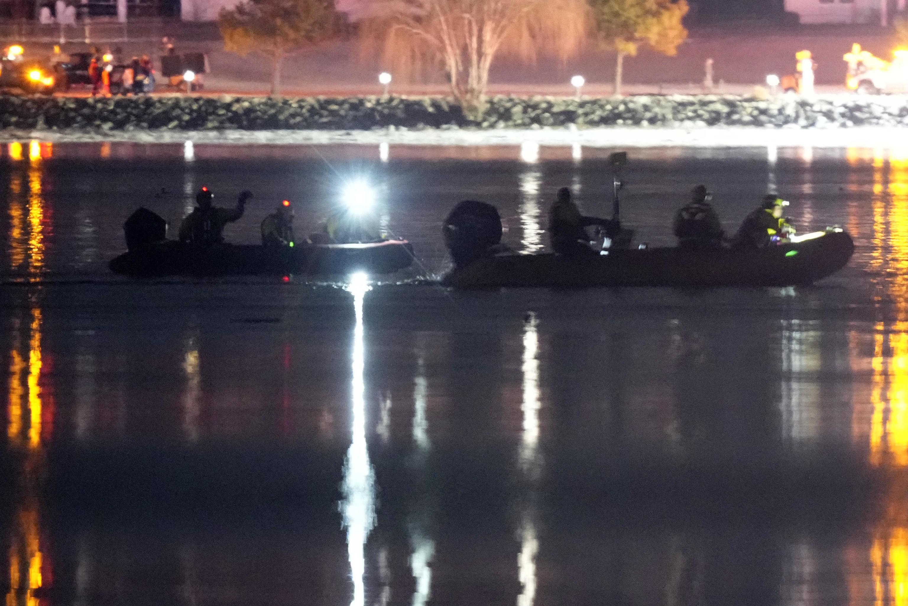 Boats work the scene in the Potomac River near Washington National Airport.
