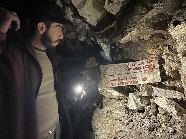 Interior of one of the tunnels in Manbij with directional signs.