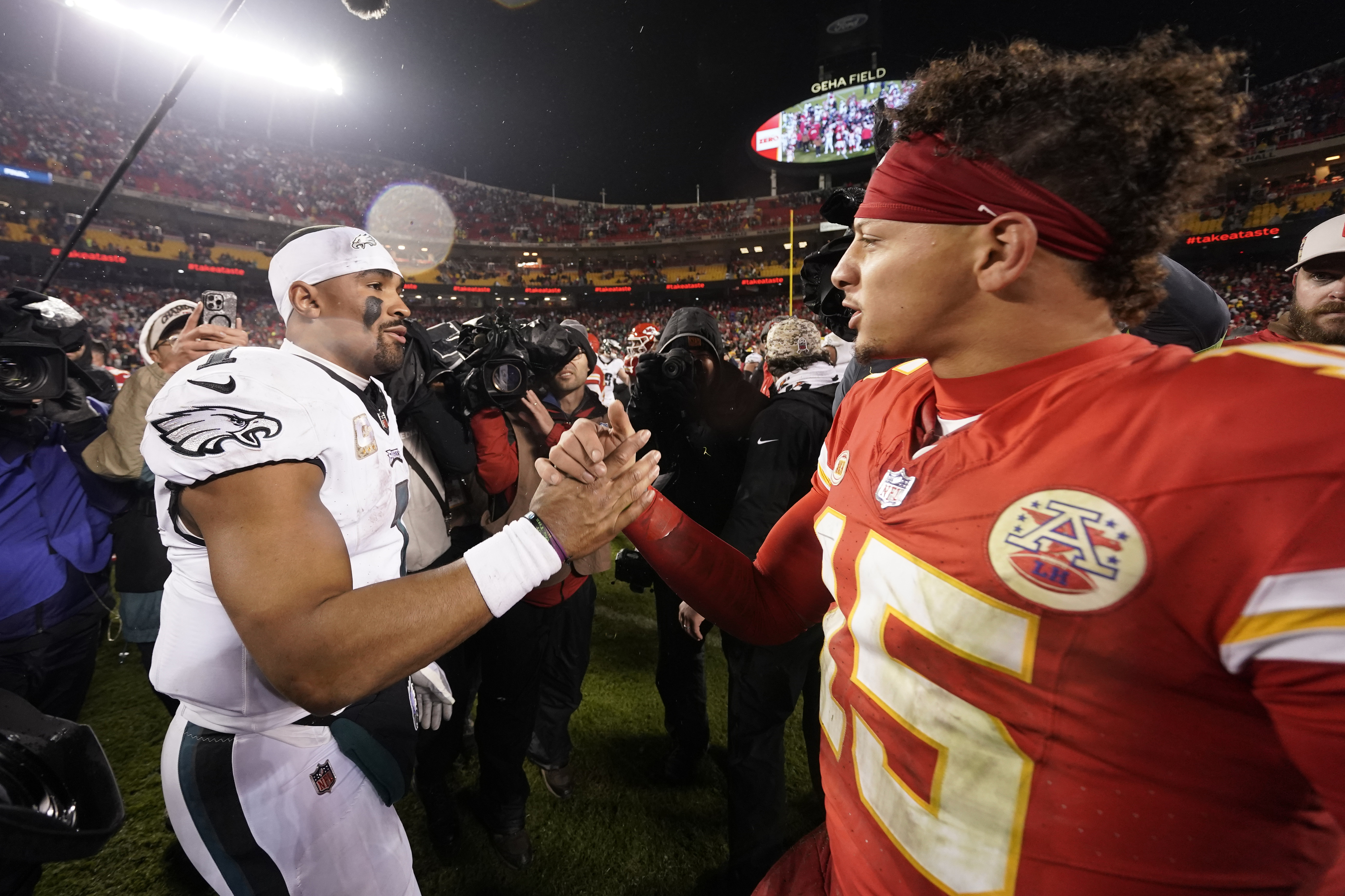 Philadelphia Eagles quarterback Jalen Hurts, left, and Kansas City Chiefs quarterback Patrick Mahomes (15) shake hands.