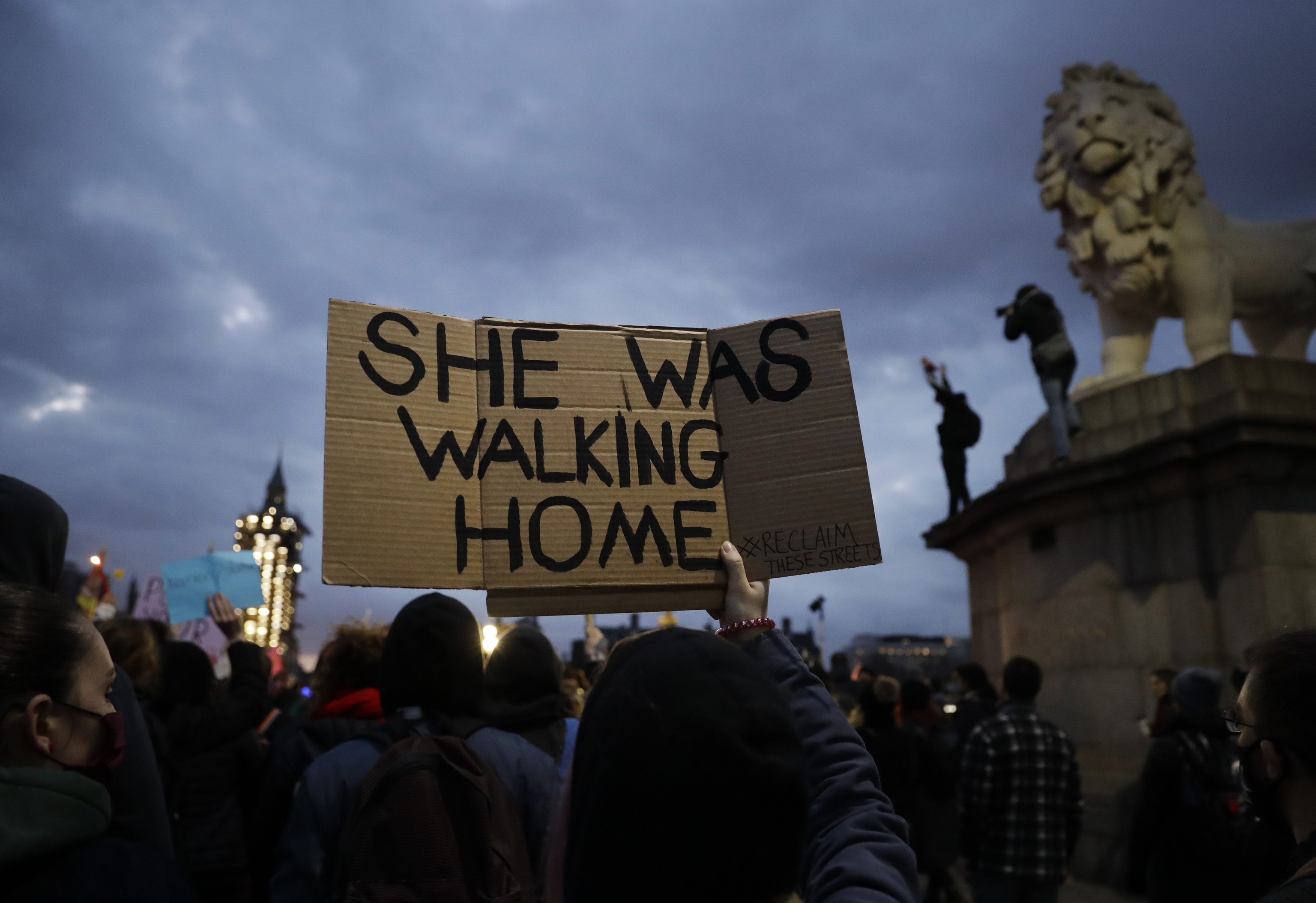 A person holds a sign near the Parliament during a march to reflect on the murder of 33 year old marketing executive, Sarah Everard, in London.