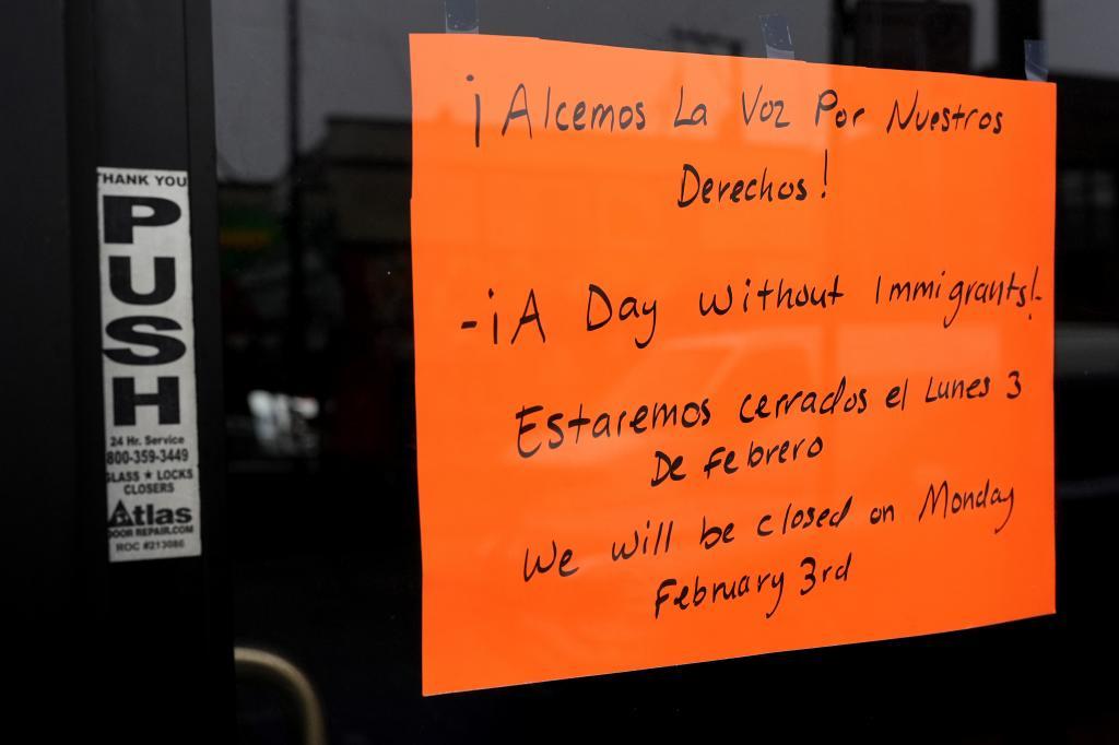 A closed sign is displayed at a local business in the Little Village neighborhood of Chicago