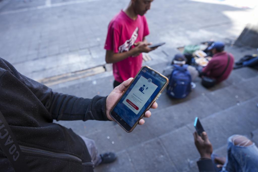 A woman takes photo with her mobile phone