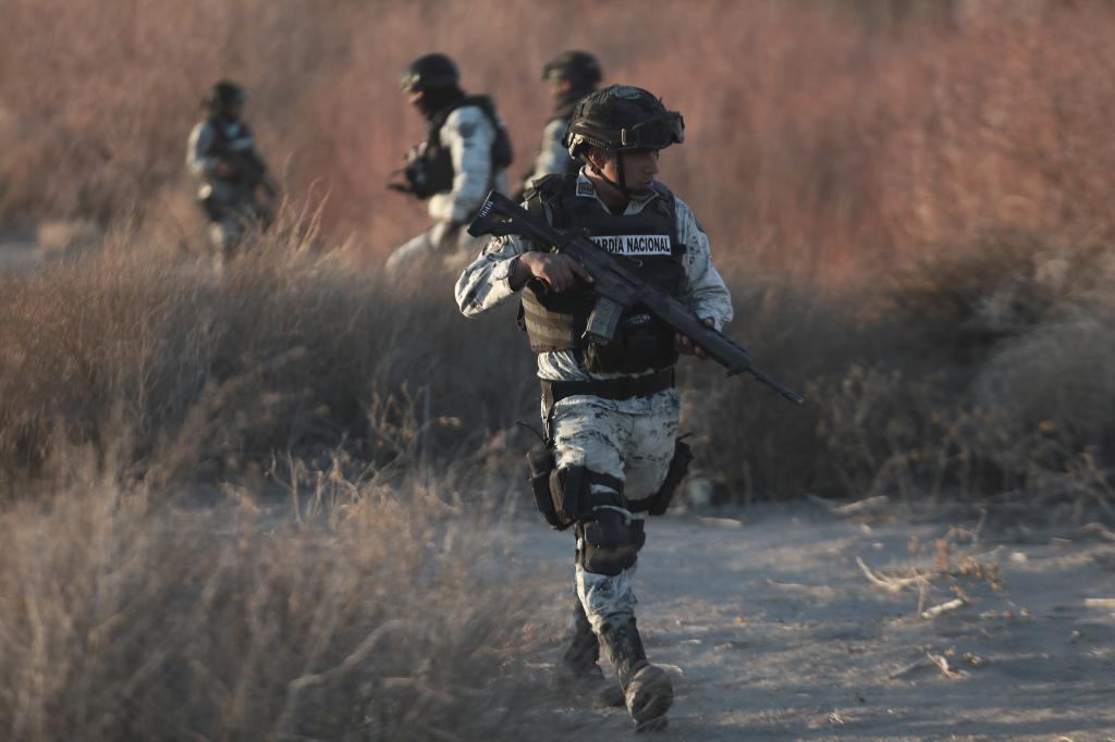 Mexican National Guard members patrol along the Mexico-US border in Ciudad Juarez