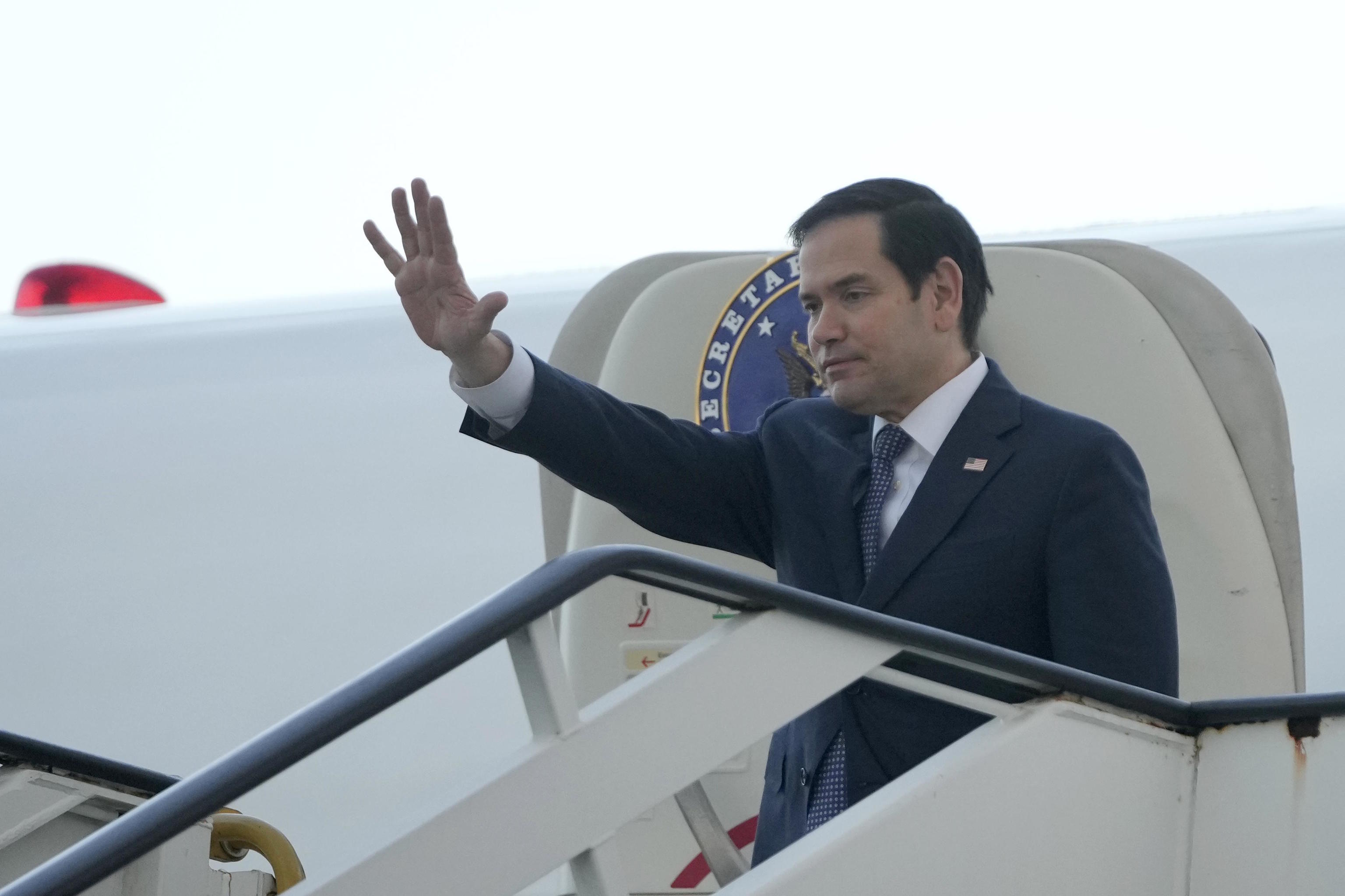 Marco Rubio waves before his departure at Las Americas International Airport in Santo Domingo.