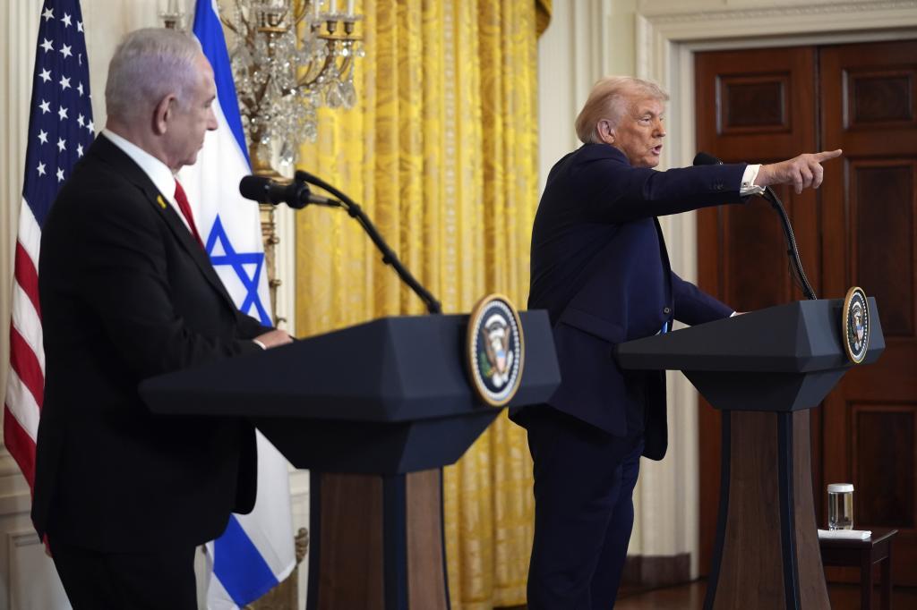 President Donald Trump calls on a reporter for a question as Israel's Prime Minister Benjamin Netanyahu watches during a news conference