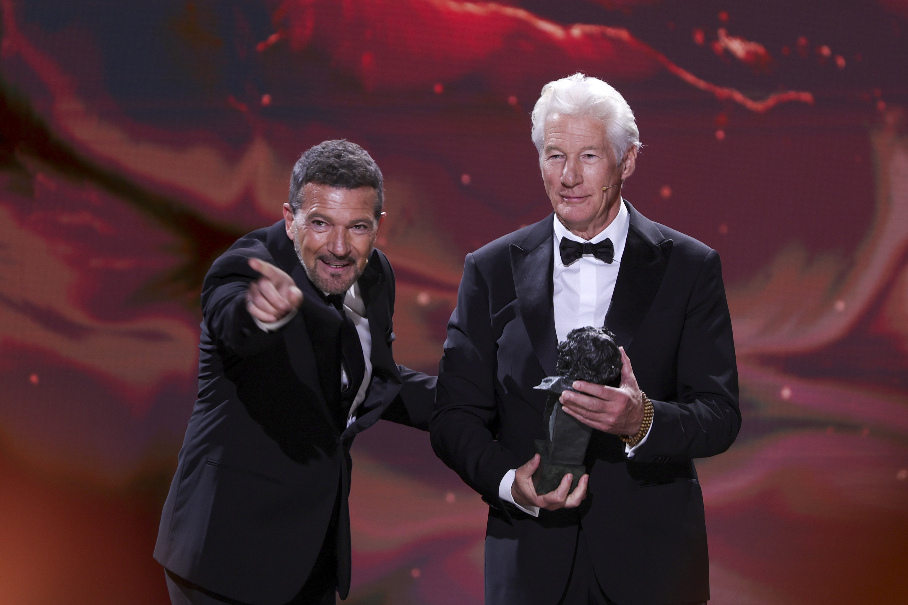 Richard Gere, right, holds the international goya award, presented by Antonio Banderas, left, during the 39th Goya Awards ceremony in Granada, Spain.