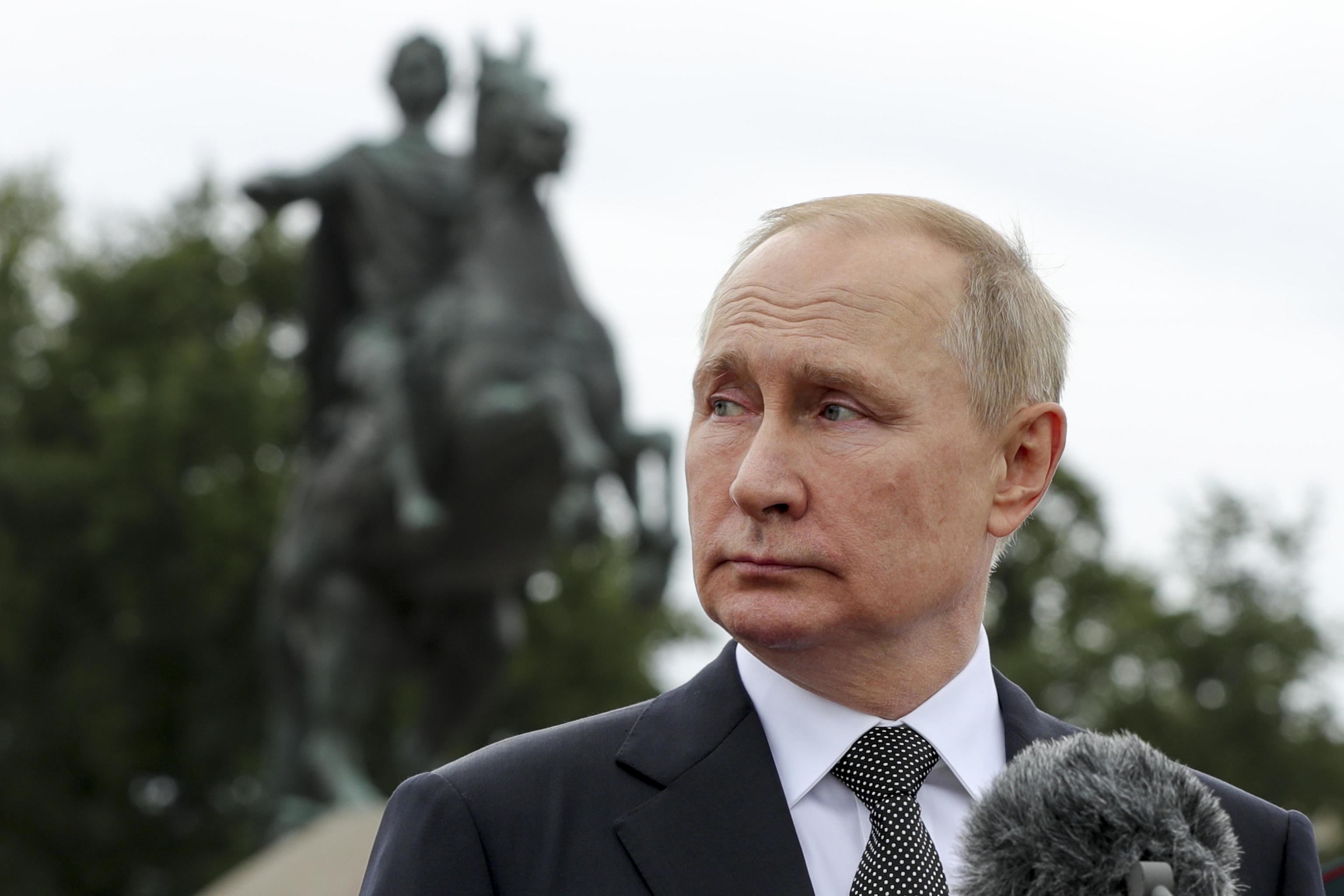 Vladimir Putin in front of the equestrian statue of Peter the Great.