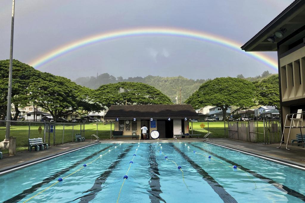 A rainbow appears in the sky