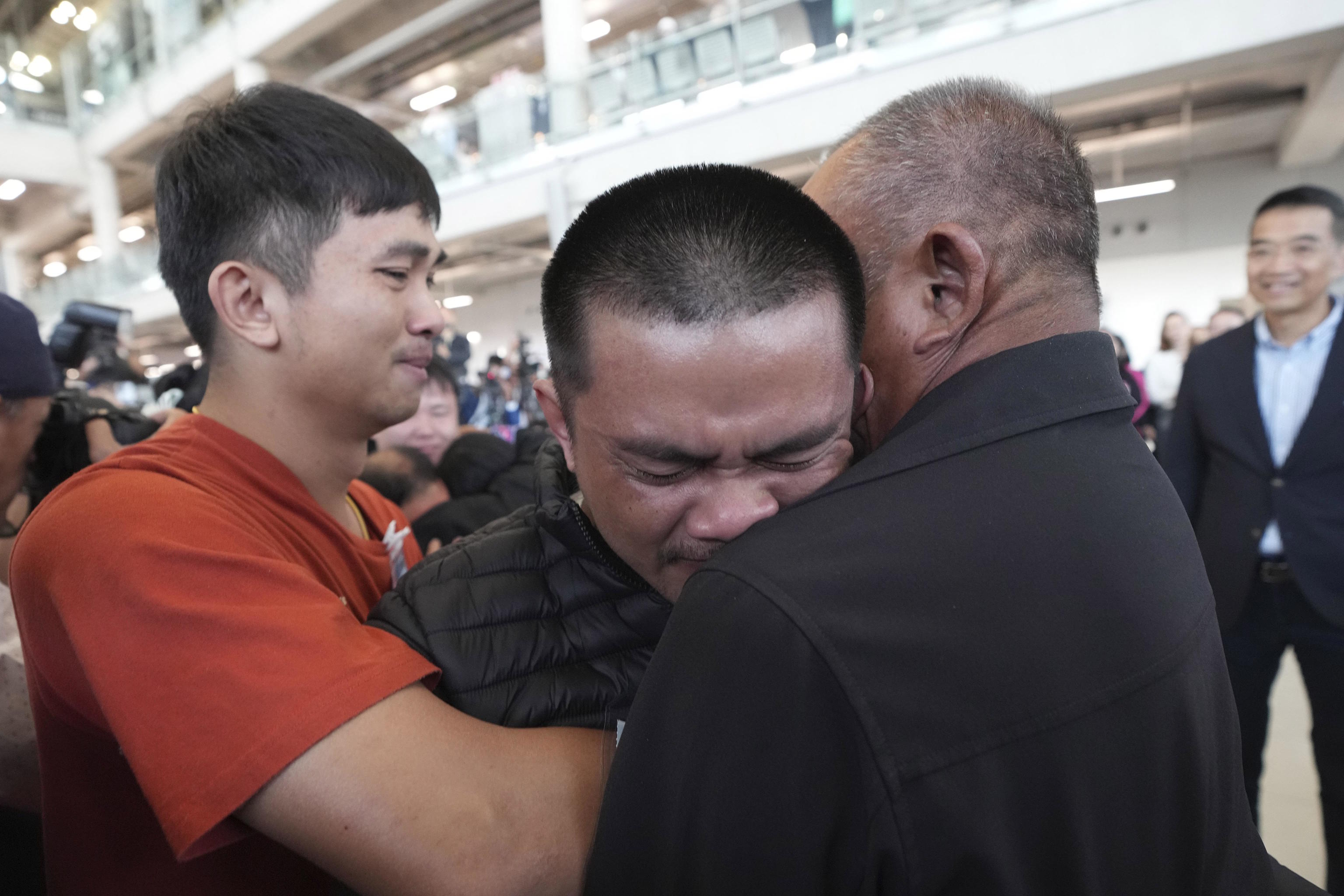 A Thai hostage who was freed from Hamas, hugs a relative upon.