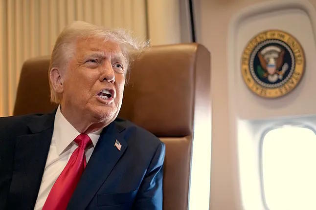 The President of the United States, Donald Trump, speaks with journalists aboard Air Force One.