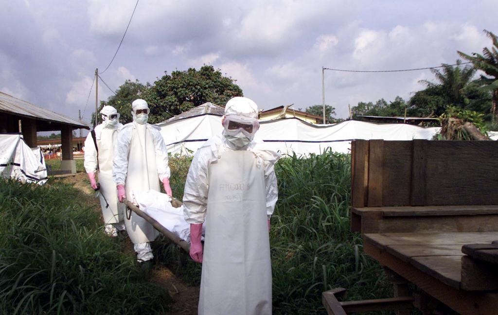 Health workers transporting the body of a five-year-old boy who died of Ebola.