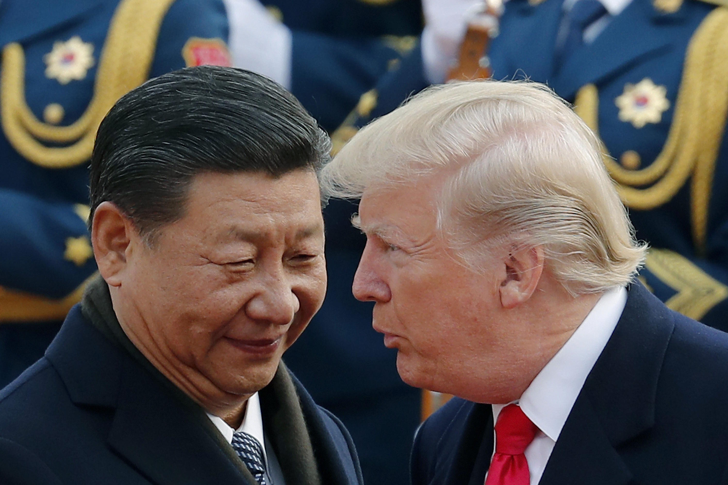 U.S. President Donald Trump, right, chats with Chinese President Xi Jinping.