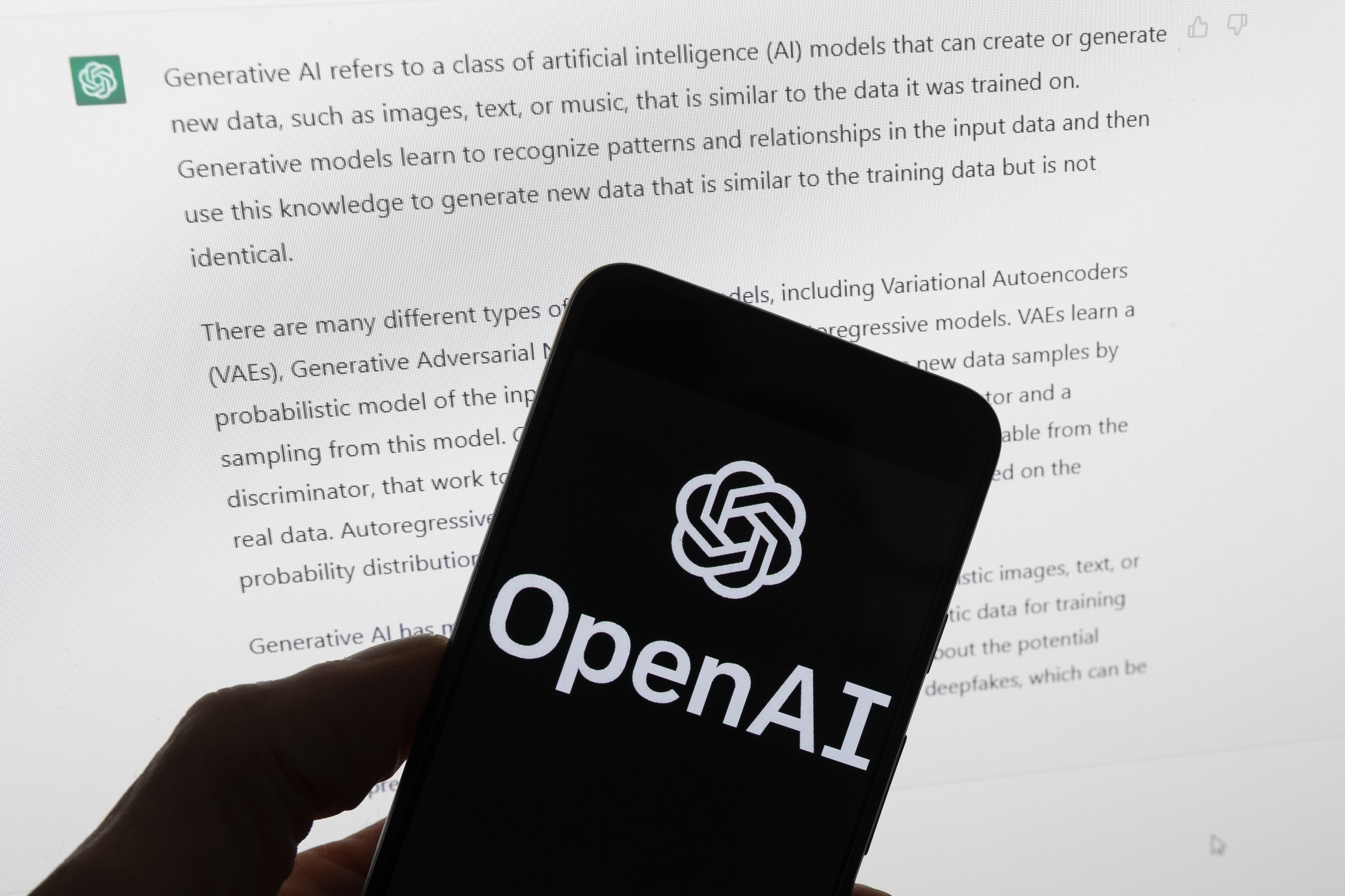 The OpenAI logo is seen on a mobile phone.