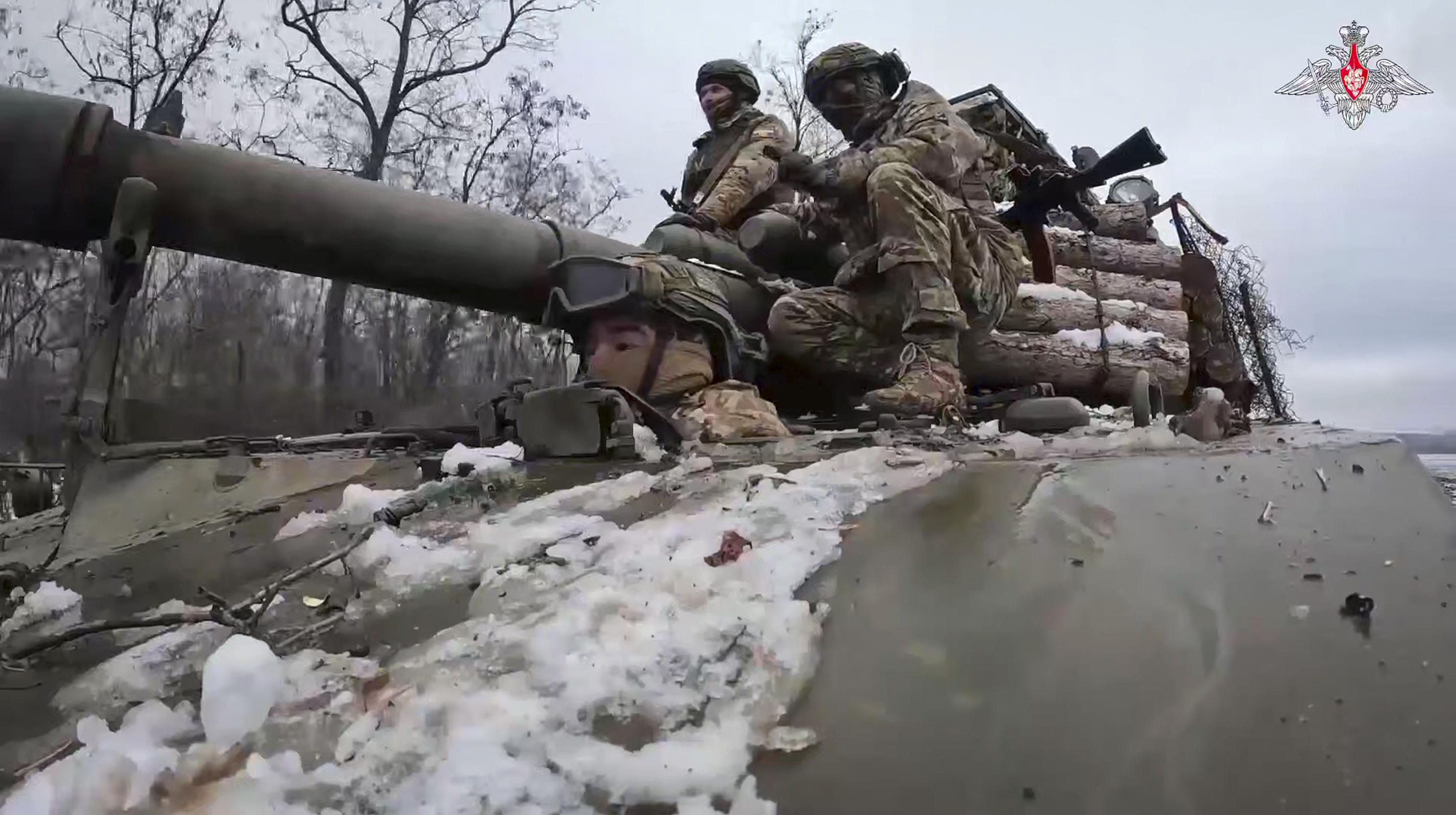 Russian soldiers ride atop Akatsyia self-propelled gun on in eastern Ukraine.