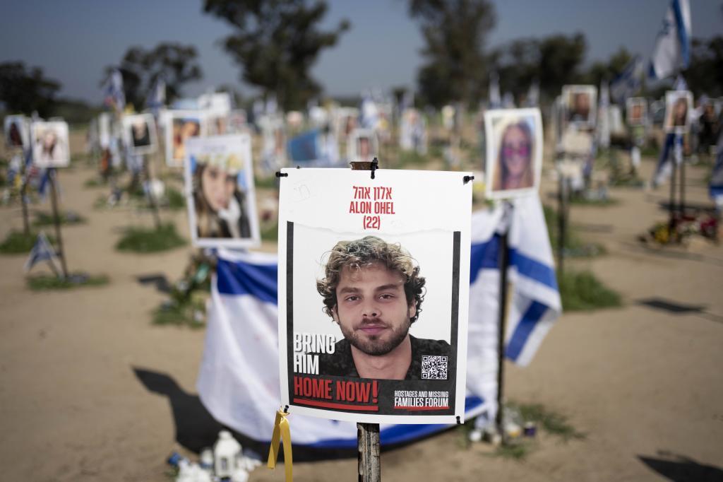 Herut Nimrodi poses for a portrait with a poster of her son, Tamir Nimrodi