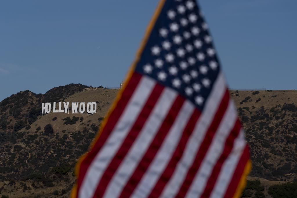 With the Hollywood sign in the background, an American flag