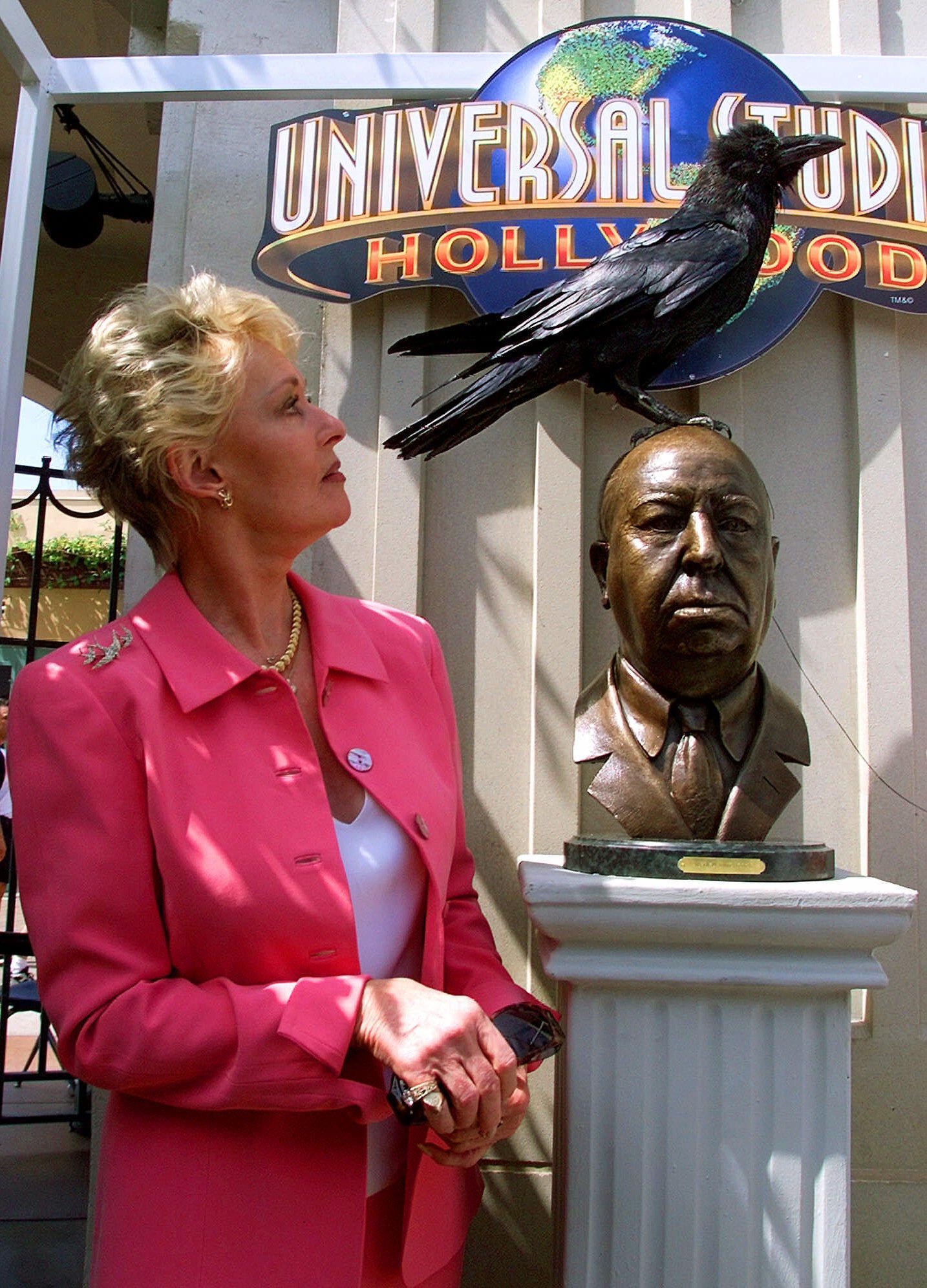 Tippi Hedren poses next to a bronze bust of Alfred Hitchcock in 1999.