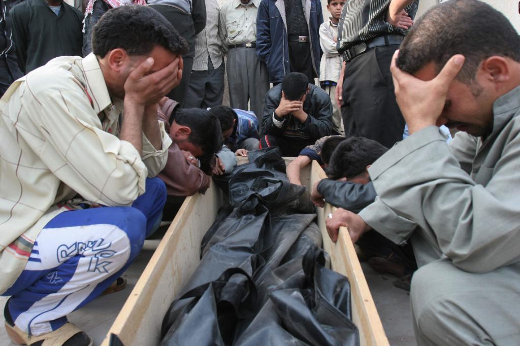 Relatives of a victim of the suicide bombing at a market near the Shiite shrine of the Imam Hussein