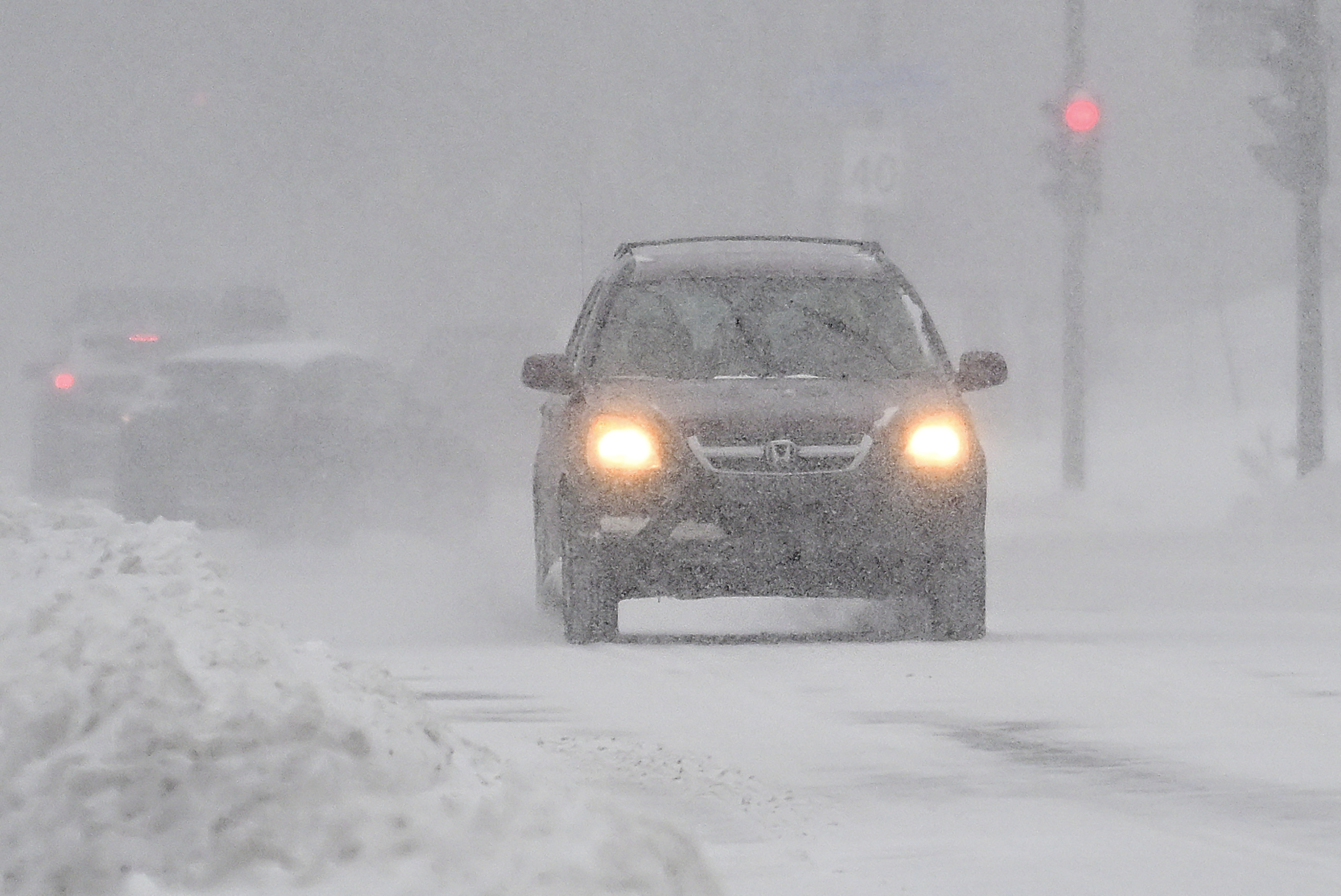 Motorists make their way along a city street during a snowstorm in Montreal.